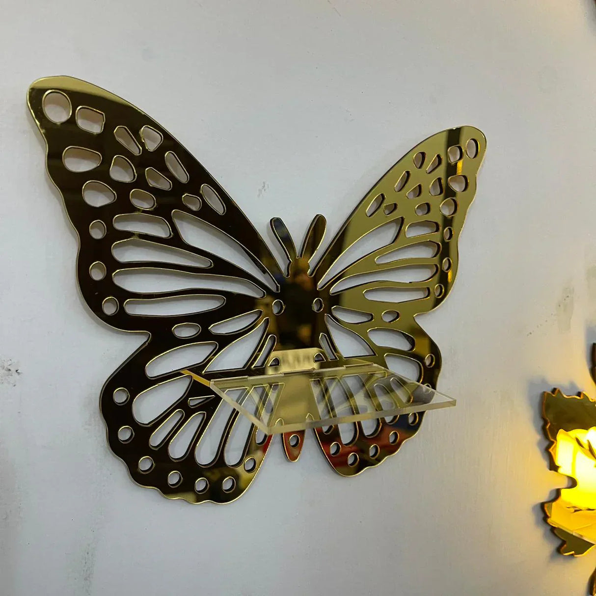 Golden acrylic wall shelves in butterfly design
