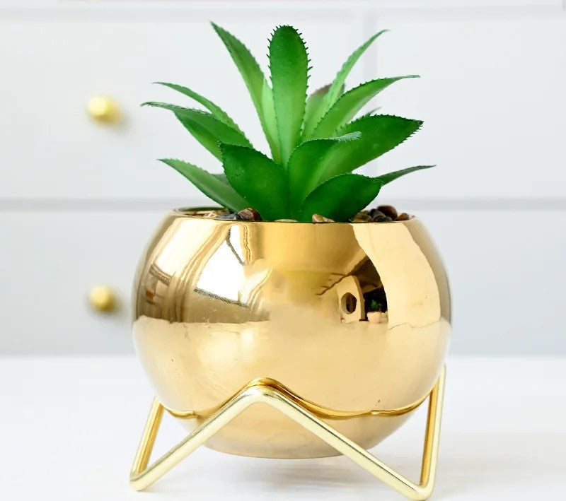 Light blue marble vases on golden stand by kitchen window