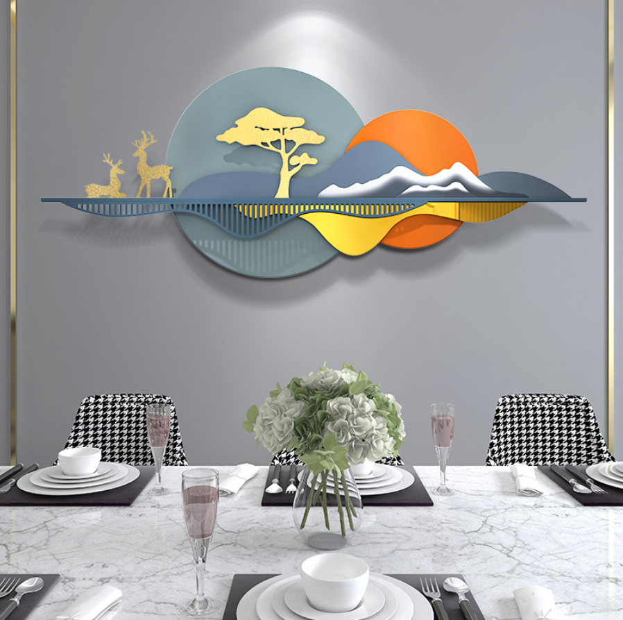 Metal wall art featuring golden deer and a sun motif