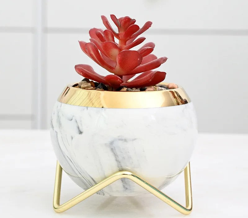 Set of pastel blue marble vases with iron stands on windowsill