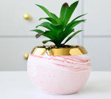 Ceramic marble vases with gold iron stand as pastel office decor
