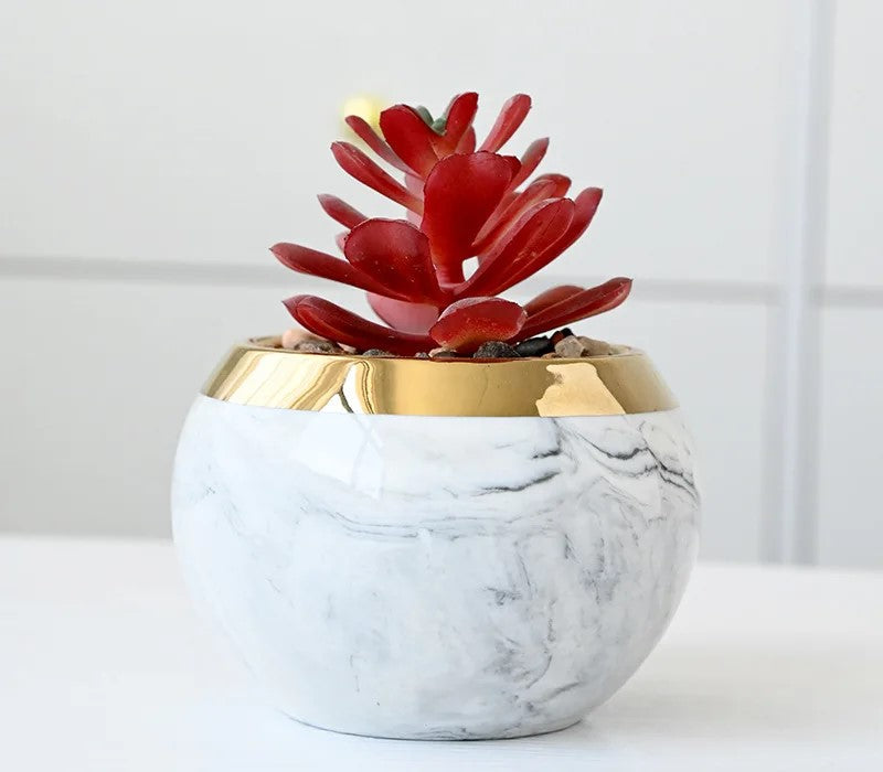 Close-up of pink marble ceramic vases with iron stand on shelf

