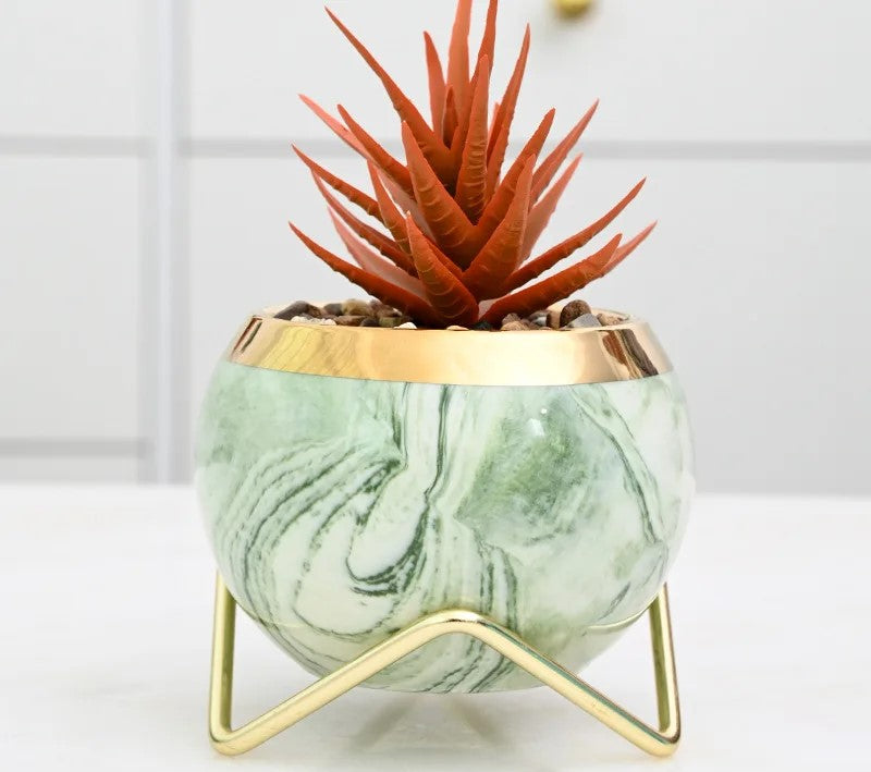 Marble vase duo with gold iron stand on wooden bookshelf
