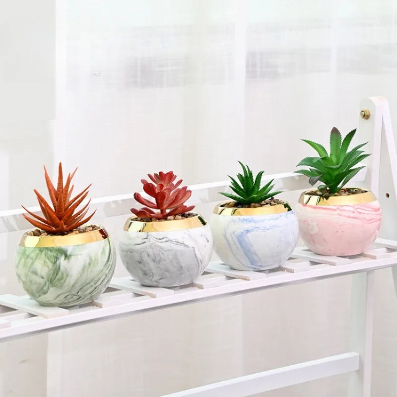 Set of marble ceramic flower pots with iron stands on table
