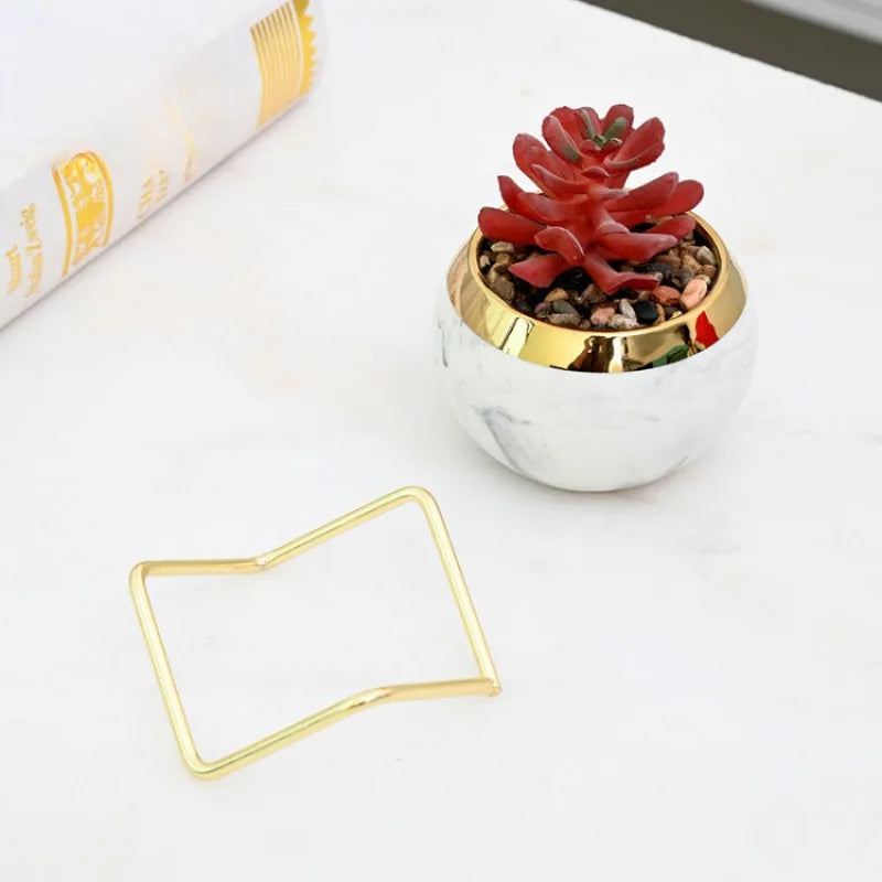Two marble vases in pastel decor style on office desk
